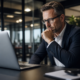 Focused businessman working on a laptop in a modern office