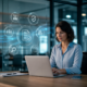Professional woman working on a laptop with digital business icons in a modern office